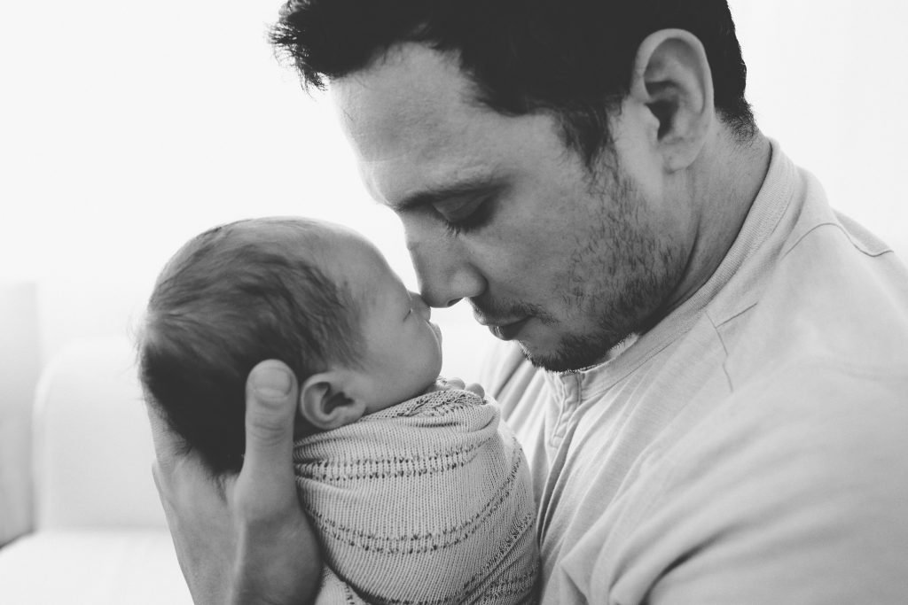 a man holding a baby in his arms