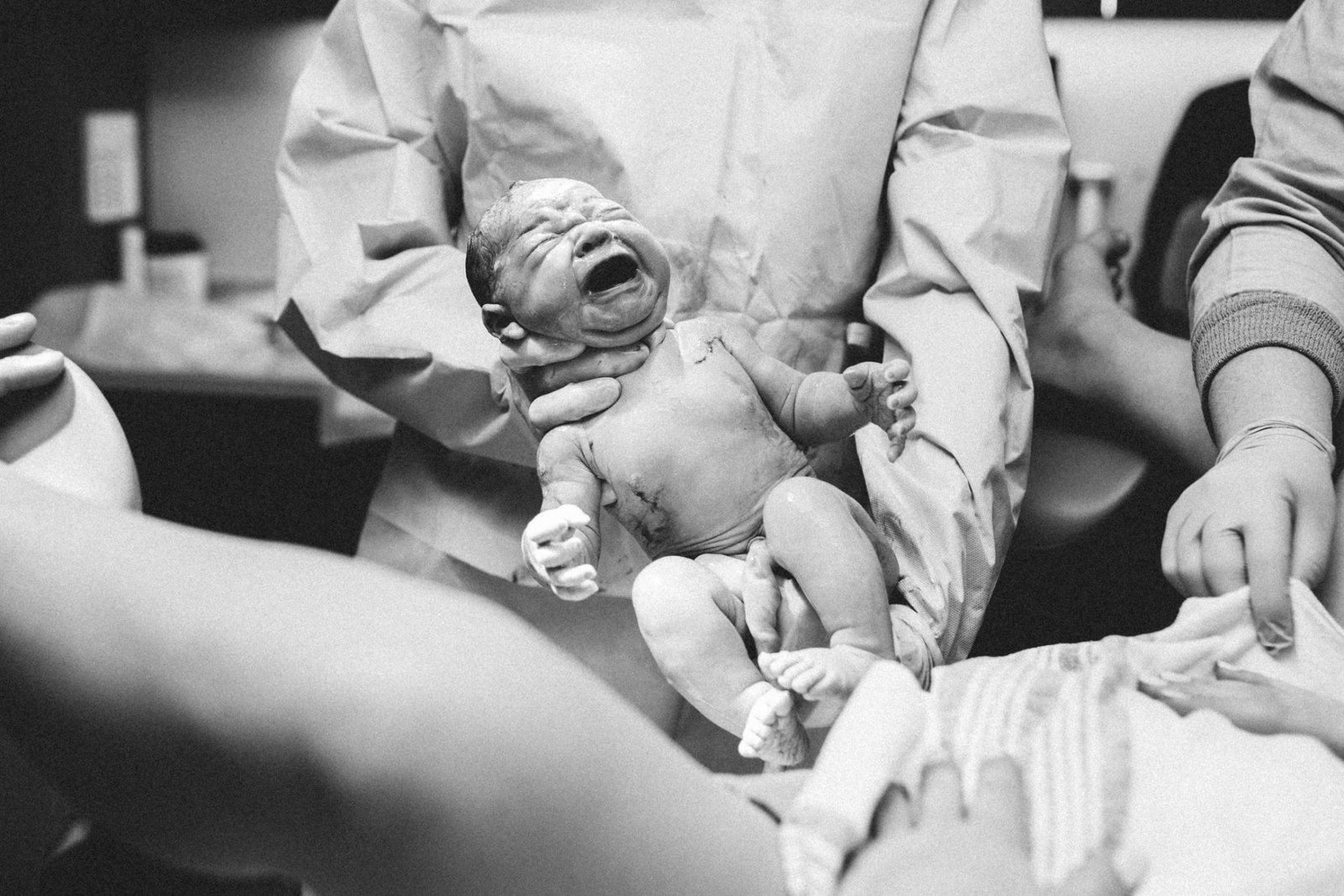 a black and white photo of a baby crying