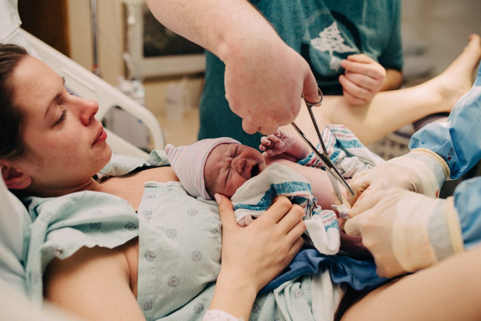 a woman is holding a baby in the hospital