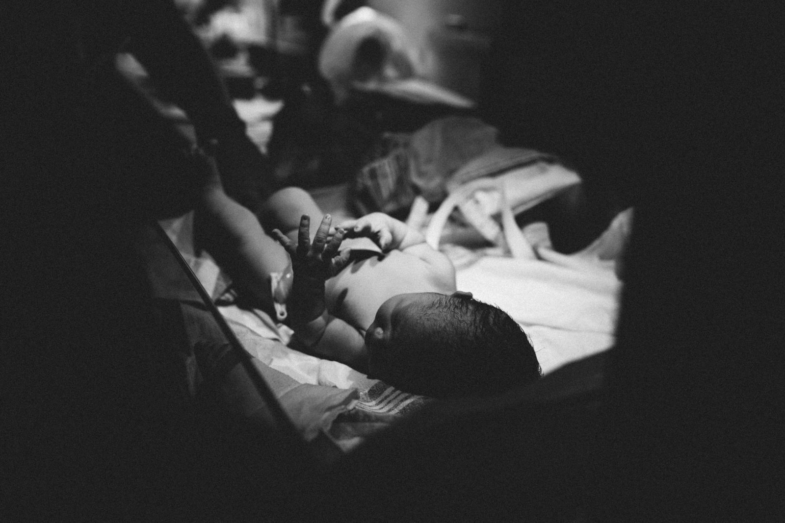 a black and white photo of a baby in a crib