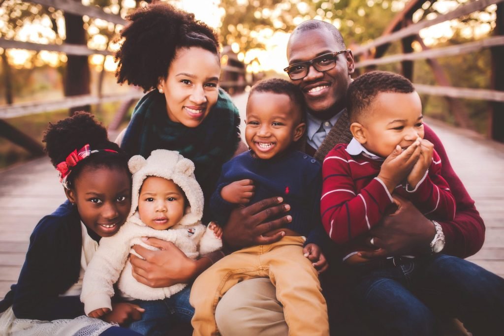 a family poses for a photo on a bridge