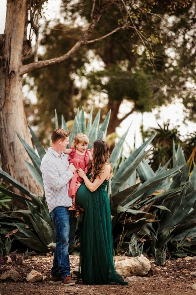 a family standing in front of some plants