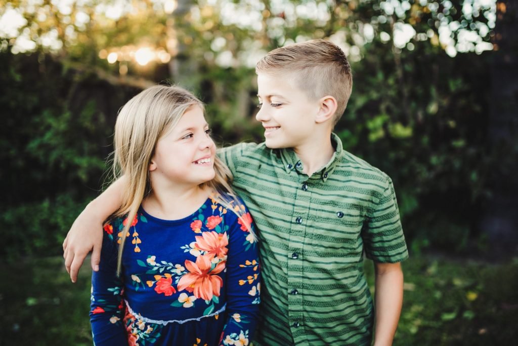 two young children standing next to each other
