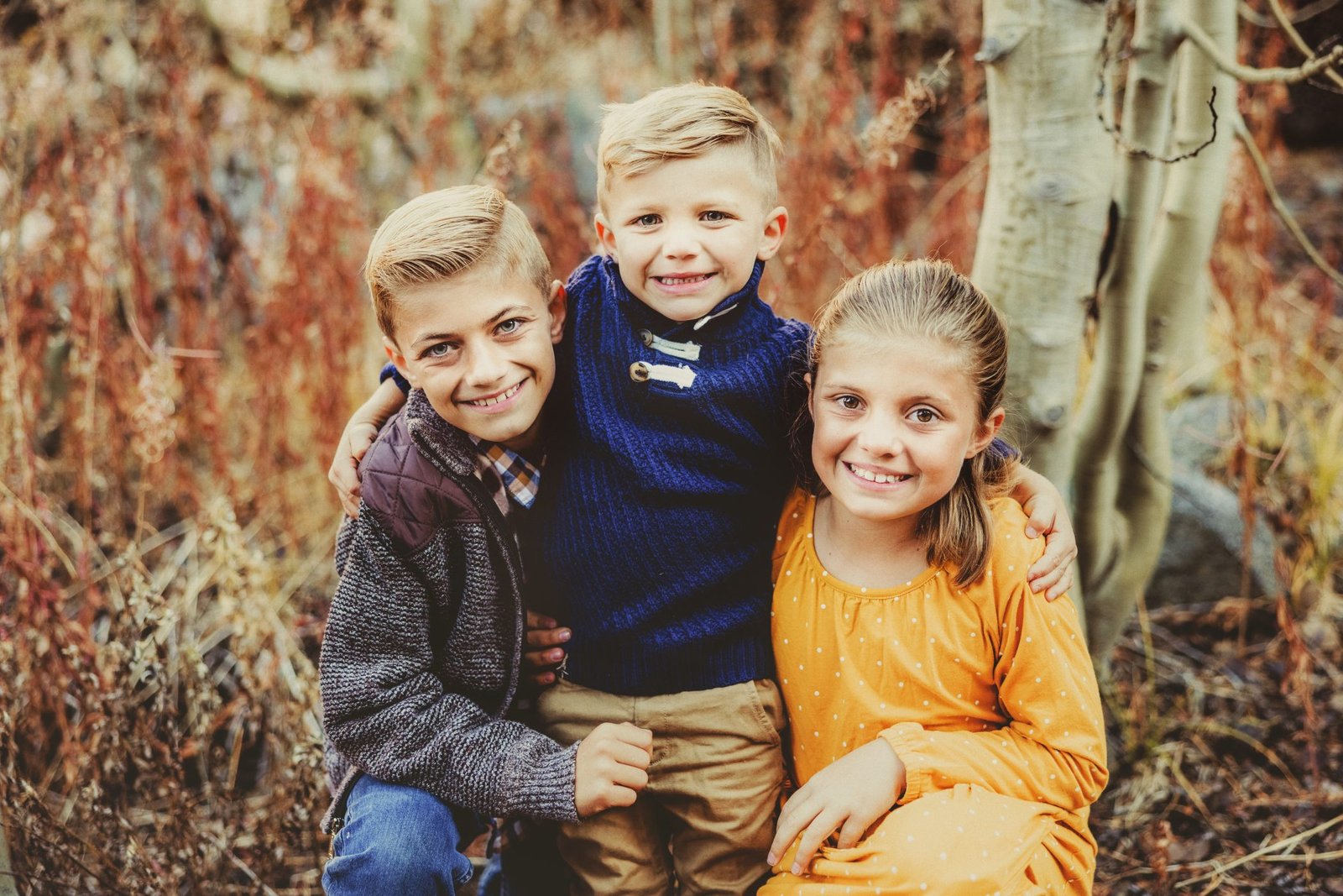 three young children are posing for the camera