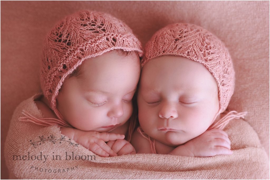 two newborn babies sleeping next to each other